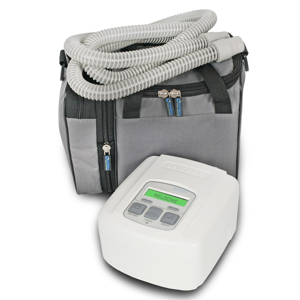 White CPAP machine with hose and bag