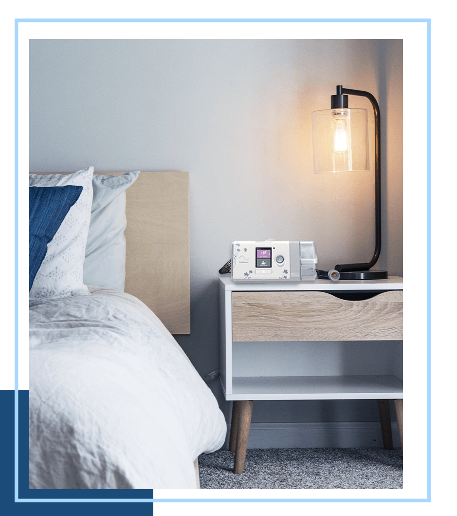A CPAP machine on a bedside table