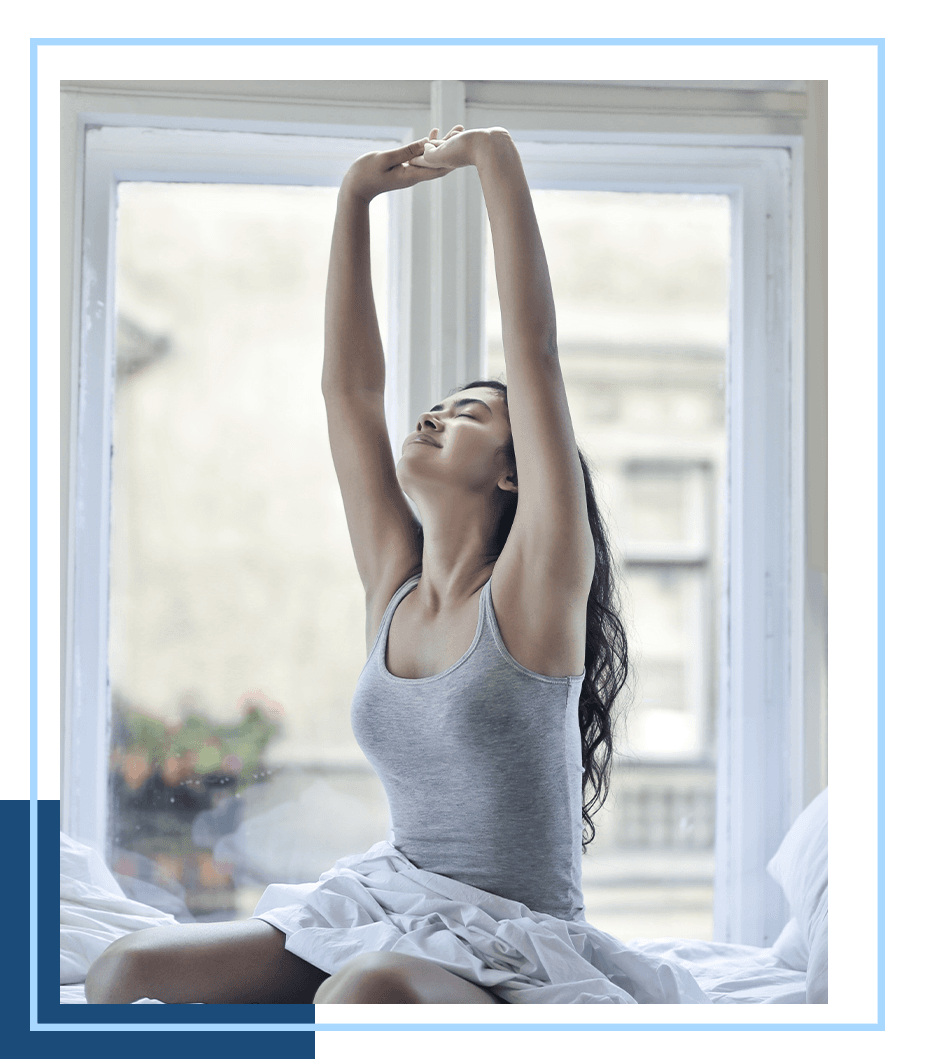 A woman stretching after waking up