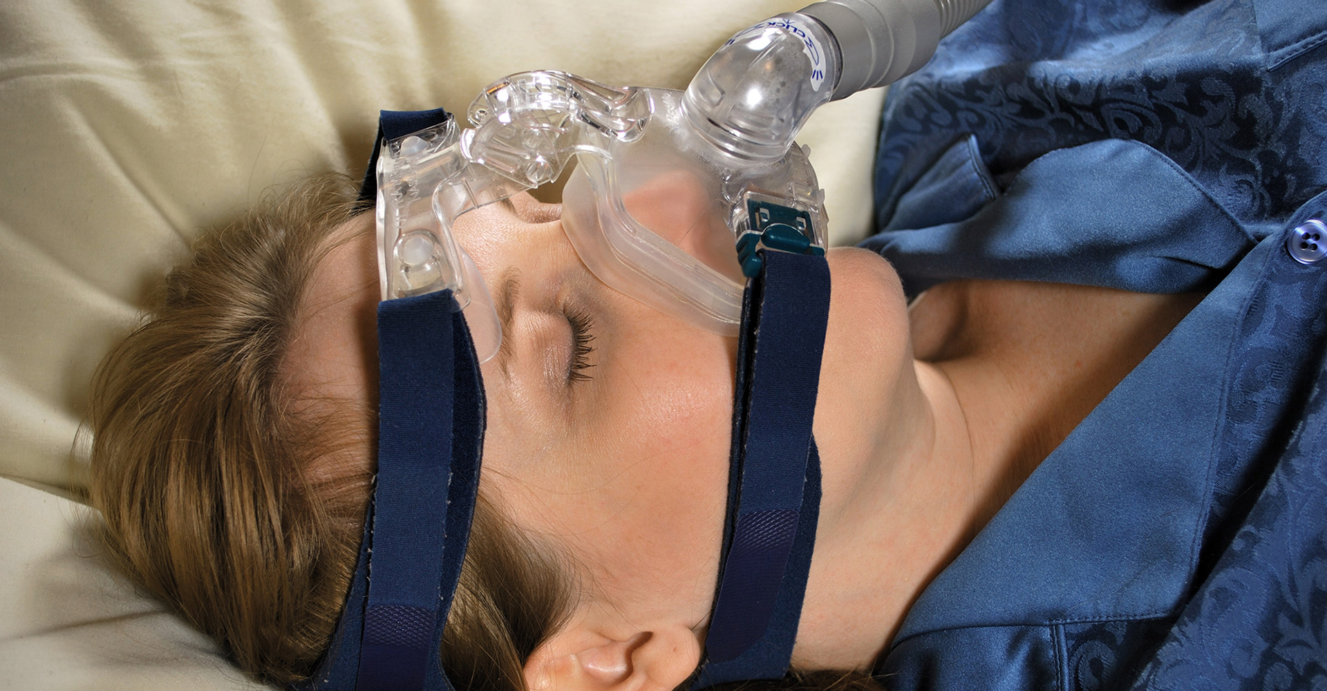 Image of a woman wearing a CPAP mask