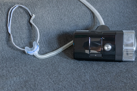 CPAP mask with a full face mask cpap machine against obstructive sleep apnea helps patients as respirator mask and headgear clip for breathing medication in snoring sleep disorder to breath easier