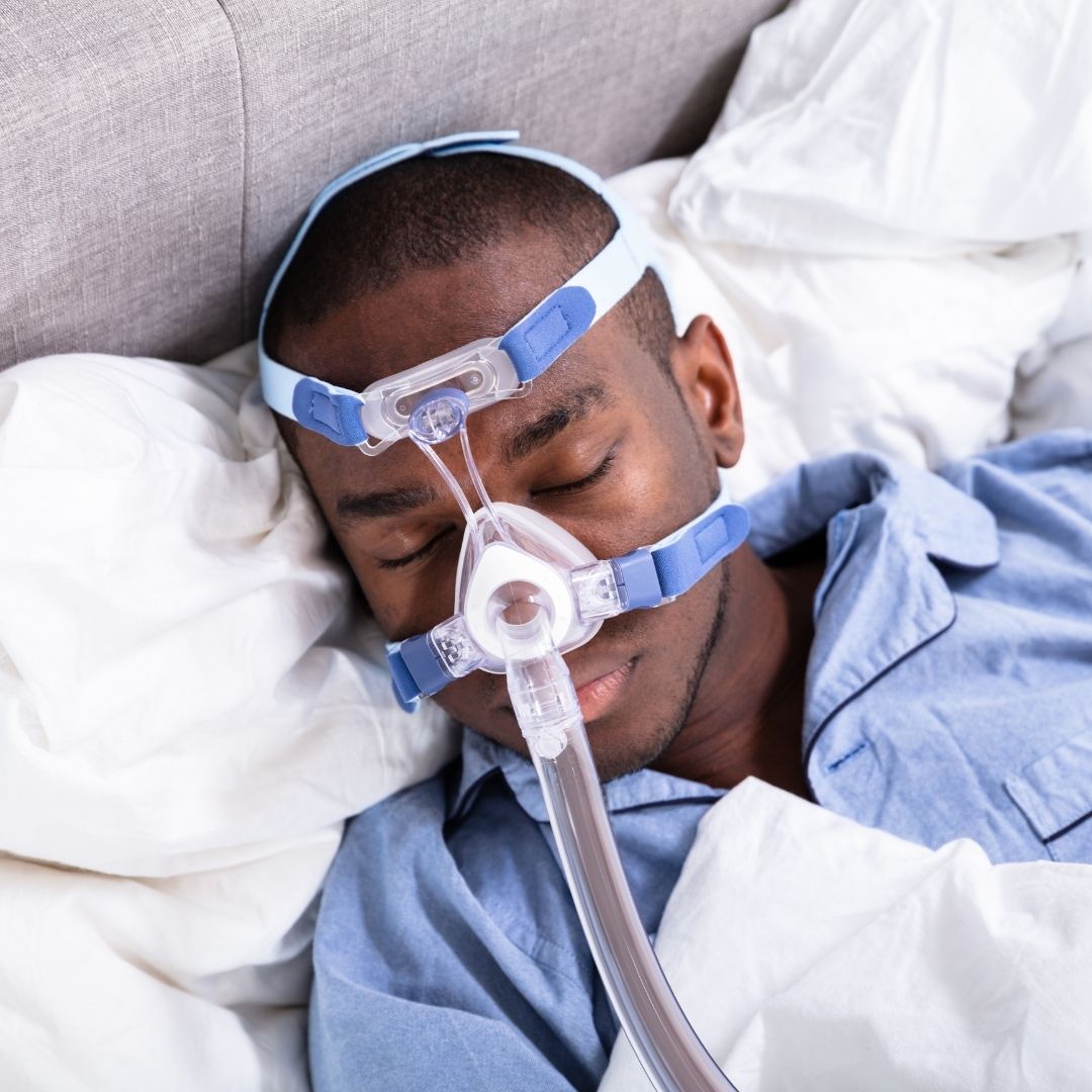 person sleeping with cpap machine on