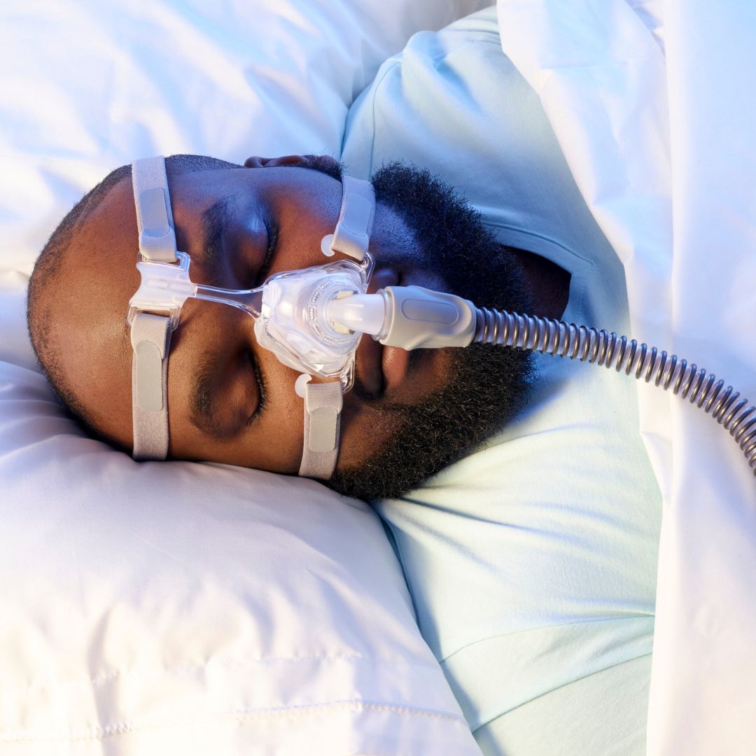 a sleeping man wearing a cpap mask