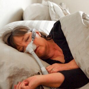 woman sleeping in CPAP machine
