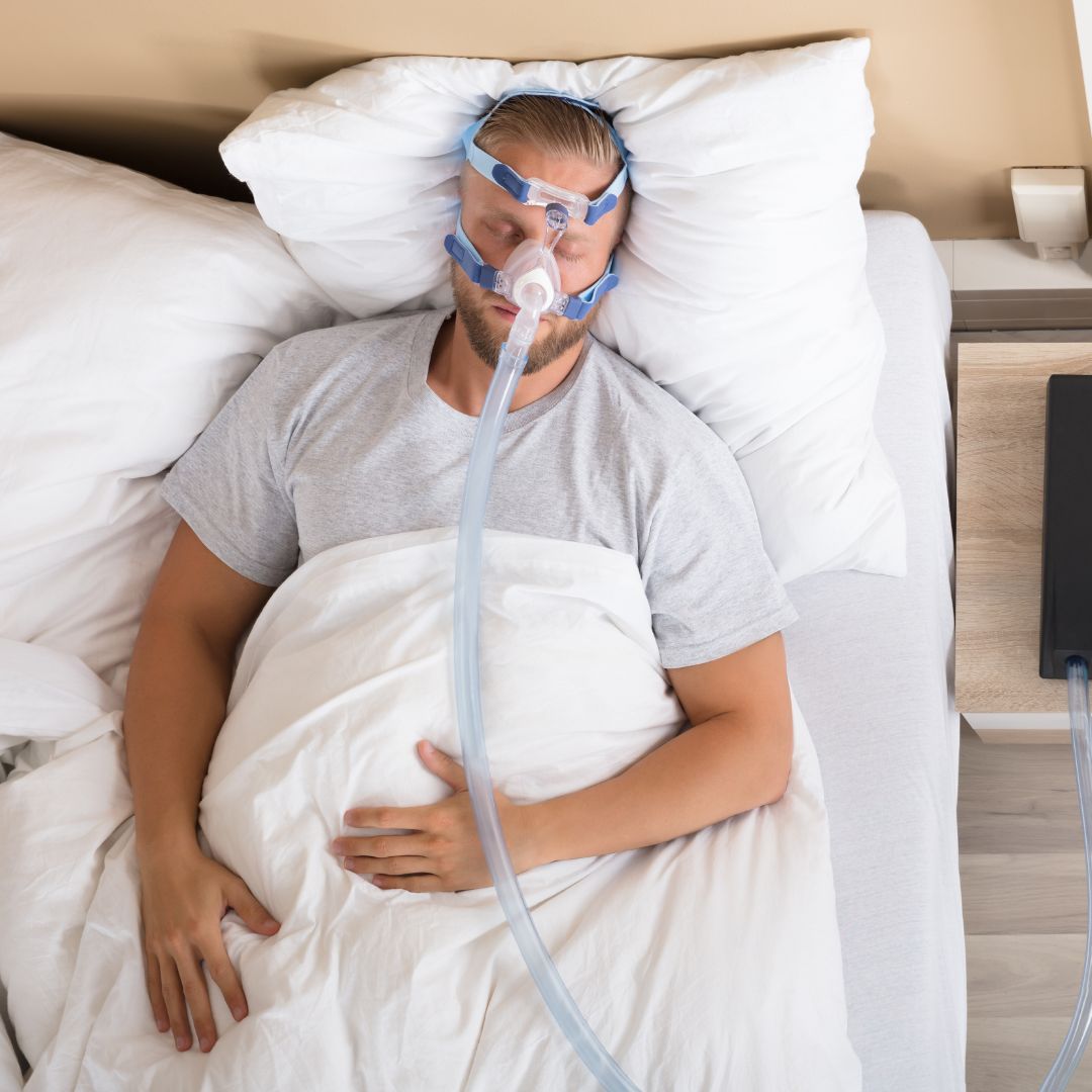 man sleeping with cpap machine