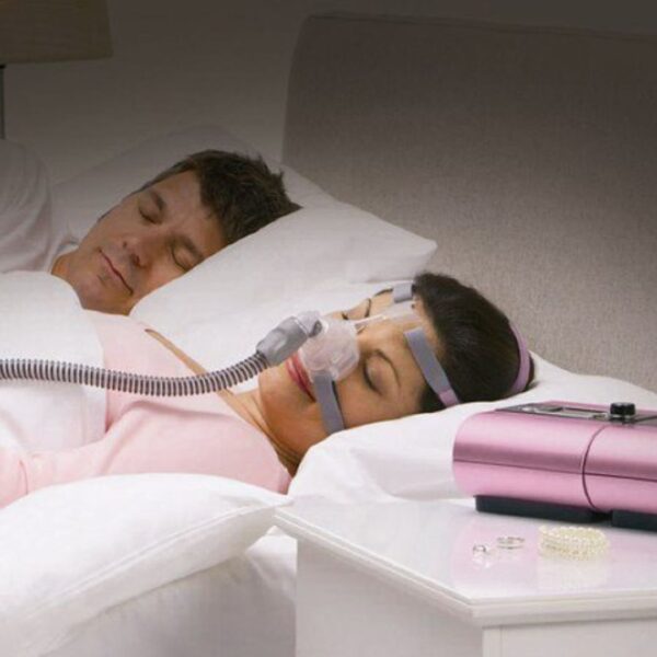 woman sleeping peacefully with cpap machine