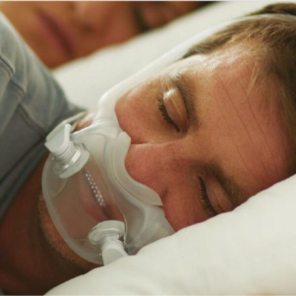 man sleeping with cpap accessories