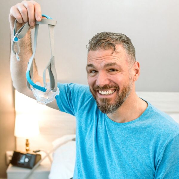 man holding CPAP mask